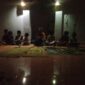 Anak-anak mengikuti pembelajaran mengaji di Musholla An-Nuur dengan penerangan terbatas akibat gangguan listrik.